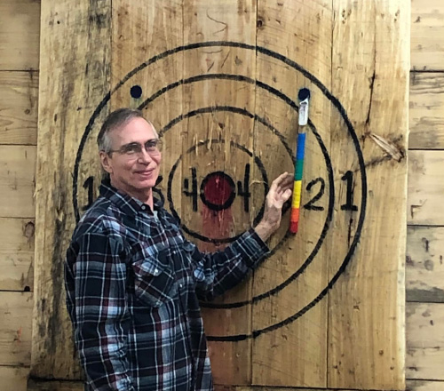 man at ax throwing event